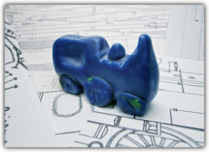 Konzipieren Das Bild zeigt die Knetfigur einer blauen Lokomotive auf dem Bauplan einer Lokomotive. Beim Mouse-over erscheint die Kurzbeschreibung: Konzipieren - Entwickeln Sie in der Konzeptentwicklung alternative Konzepte zur Umsetzung der Ziele und entscheiden Sie sich für ein Konzept.<br />©memephoto